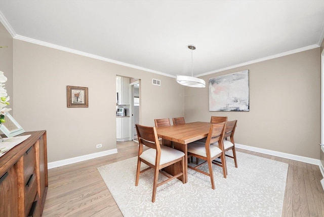 905 W Palm Dr, Mount Prospect, IL 60056 - dining space featuring light wood-type flooring and ornamental molding