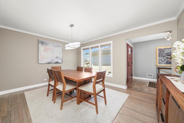 905 W Palm Dr, Mount Prospect, IL 60056 - dining space with crown molding and light wood-style flooring