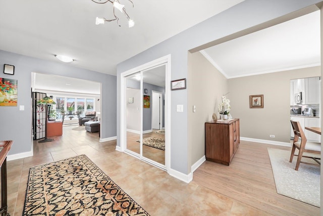 905 W Palm Dr, Mount Prospect, IL 60056 - corridor with a chandelier, ornamental molding, and light tile patterned floors