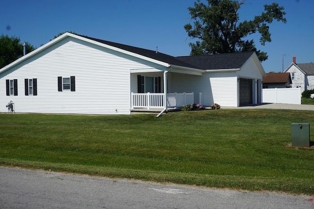 view of side of property featuring an attached garage, concrete driveway, and roof with shingles