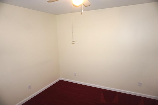 spare room with ceiling fan and dark wood finished floors