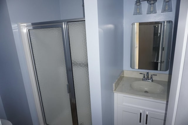 bathroom featuring a stall shower and vanity