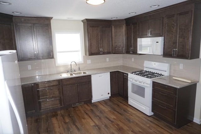 kitchen with white appliances, tasteful backsplash, dark wood-style flooring, and dark brown cabinetry