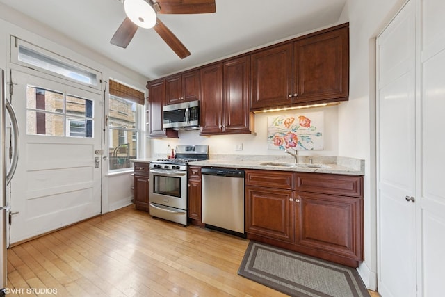 5308 N Glenwood Ave Unit 3N, Chicago, IL 60640 - kitchen with stainless steel appliances, light wood finished floors, ceiling fan, and light stone counters