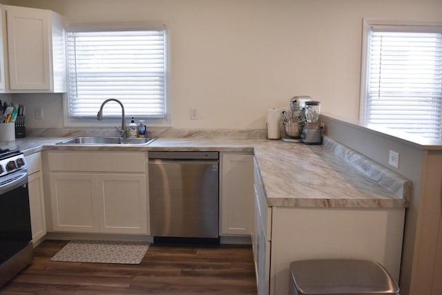631 Central Ave, Joliet, IL 60436 - kitchen with appliances with stainless steel finishes, white cabinetry, dark wood-type flooring, and a peninsula