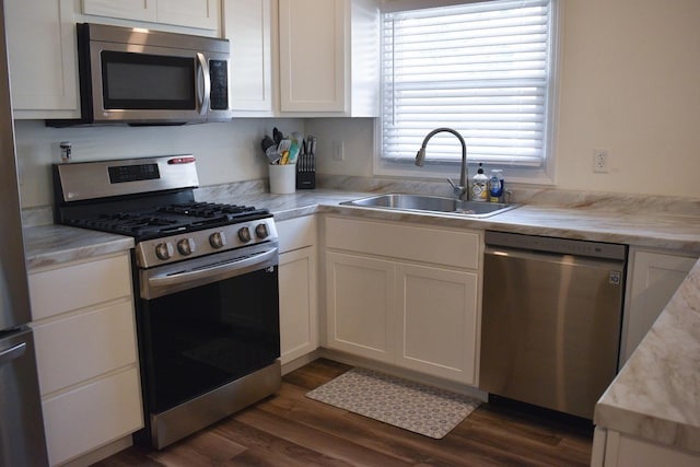 631 Central Ave, Joliet, IL 60436 - kitchen with stainless steel appliances, light countertops, white cabinetry, and dark wood-type flooring