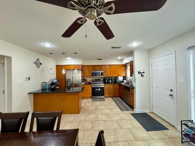 1S215 Stratford Ln, Villa Park, IL 60181 - kitchen featuring stainless steel appliances, dark countertops, ceiling fan, brown cabinets, and a peninsula