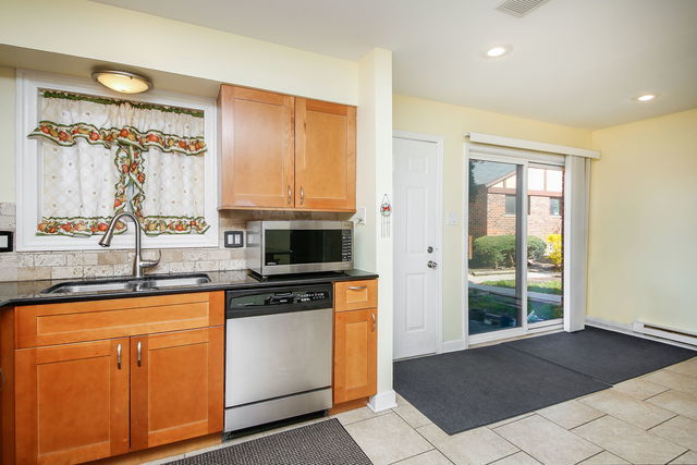 1S215 Stratford Ln, Villa Park, IL 60181 - kitchen featuring appliances with stainless steel finishes, dark countertops, decorative backsplash, light tile patterned floors, and recessed lighting