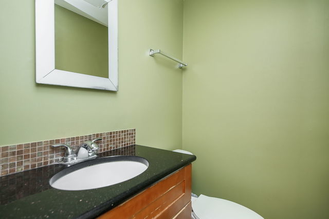 1S215 Stratford Ln, Villa Park, IL 60181 - bathroom featuring vanity and backsplash