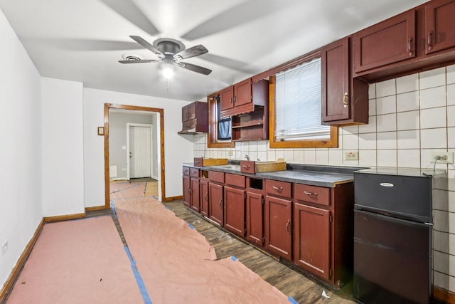 9720 S Exchange Ave, Chicago, IL 60617 - kitchen featuring freestanding refrigerator, a ceiling fan, backsplash, dark countertops, and dark wood-style floors