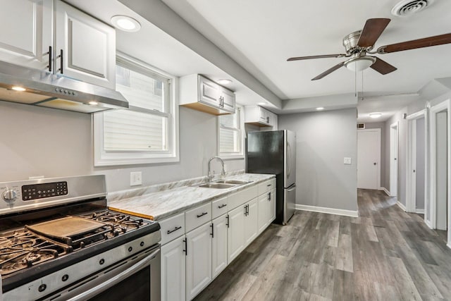 9720 S Exchange Ave, Chicago, IL 60617 - kitchen with appliances with stainless steel finishes, a ceiling fan, light wood-style floors, white cabinetry, and recessed lighting