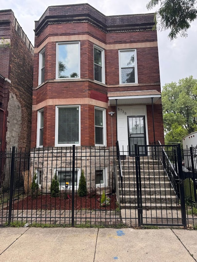 5738 S Carpenter St, Chicago, IL 60621 - view of front of property with a fenced front yard and brick siding