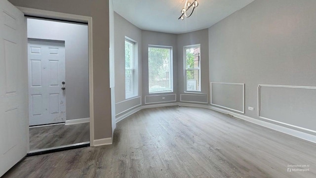 5738 S Carpenter St, Chicago, IL 60621 - empty room with wood finished floors and a chandelier