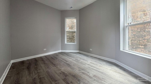 5738 S Carpenter St, Chicago, IL 60621 - spare room featuring dark wood-style flooring