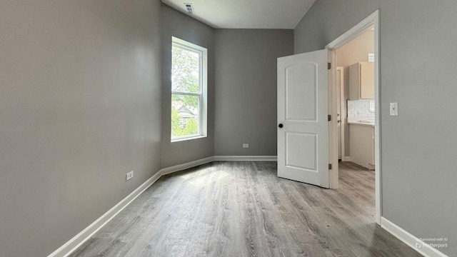 5738 S Carpenter St, Chicago, IL 60621 - unfurnished room featuring wood finished floors and healthy amount of natural light