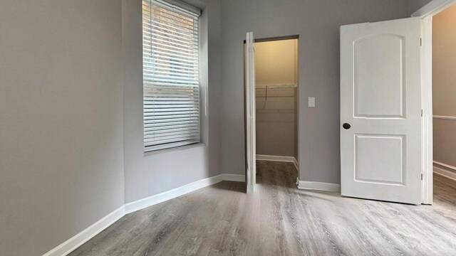 5738 S Carpenter St, Chicago, IL 60621 - unfurnished bedroom with a spacious closet and wood finished floors