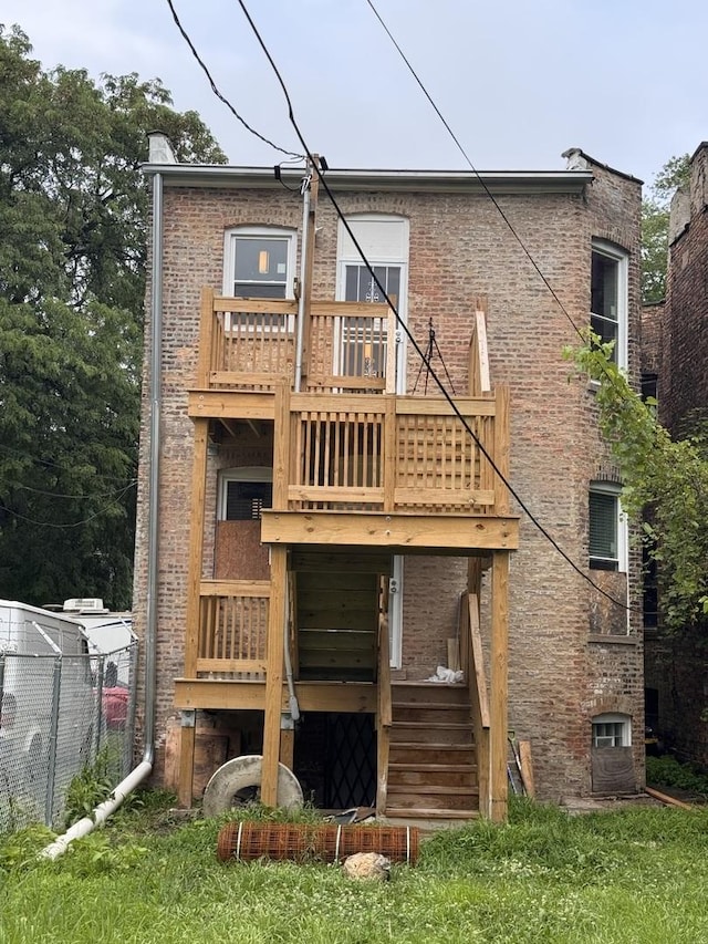 5738 S Carpenter St, Chicago, IL 60621 - back of property featuring stairs, brick siding, and a deck