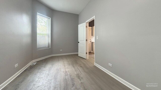 5738 S Carpenter St, Chicago, IL 60621 - unfurnished bedroom with wood finished floors and baseboards