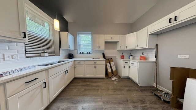 5738 S Carpenter St, Chicago, IL 60621 - kitchen with decorative backsplash, dark wood finished floors, white cabinets, and hanging light fixtures