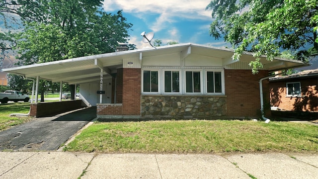 15043 Meadow Ln, Dolton, IL 60419 - view of front of home with driveway, a front lawn, a carport, and brick siding