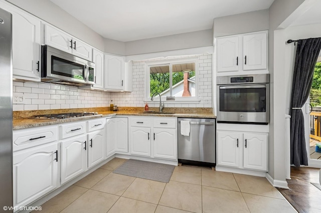 1426 E Kenilworth Ave, Palatine, IL 60074 - kitchen featuring stainless steel appliances, healthy amount of natural light, backsplash, and white cabinetry