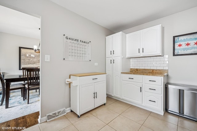1426 E Kenilworth Ave, Palatine, IL 60074 - kitchen featuring white cabinets, tasteful backsplash, light tile patterned floors, and a chandelier