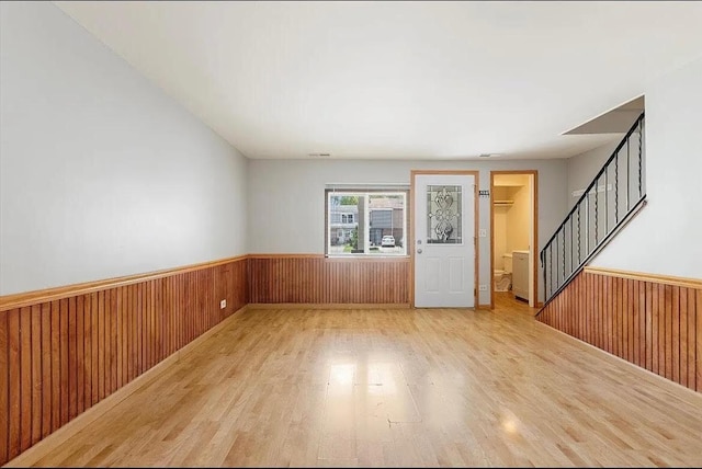 2049 Berkshire Cir Unit D, Carpentersville, IL 60110 - spare room with wood finished floors, a wainscoted wall, wood walls, and stairs