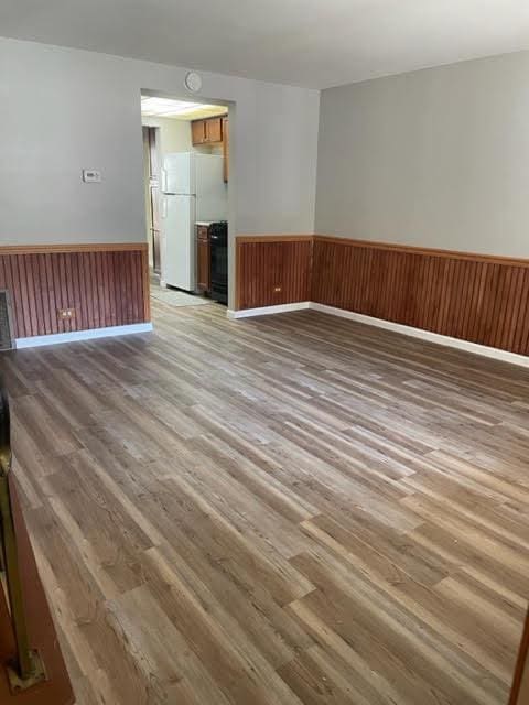 2049 Berkshire Cir Unit D, Carpentersville, IL 60110 - empty room with a wainscoted wall and light wood-style floors
