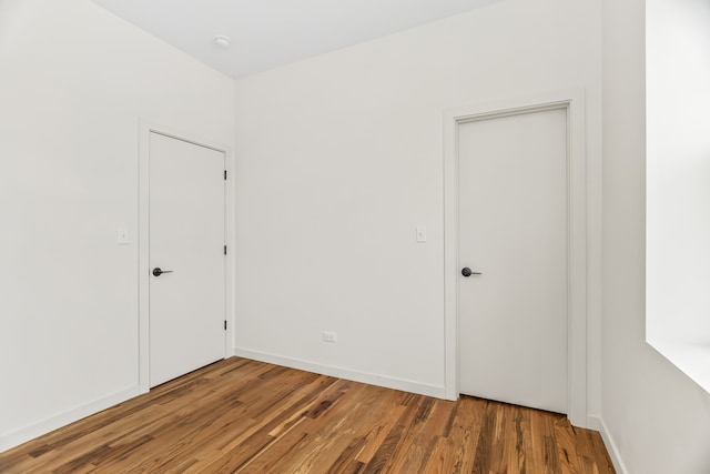 4316 S Michigan Ave Unit 1S, Chicago, IL 60653 - unfurnished bedroom with wood finished floors and baseboards