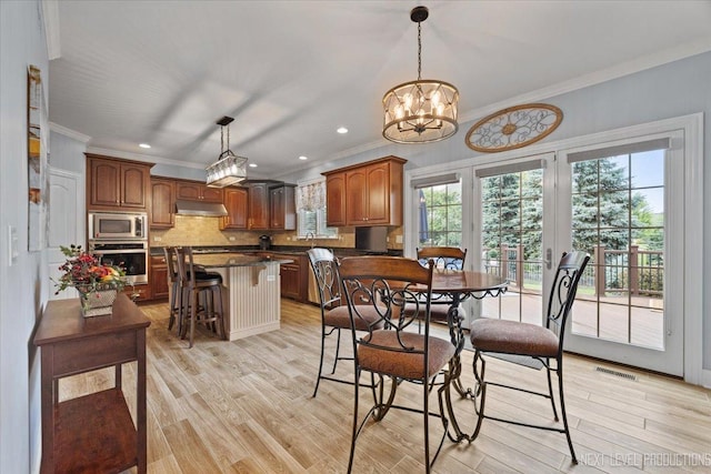 1108 Independence Ave, Elburn, IL 60119 - dining space with crown molding, light wood finished floors, a chandelier, and recessed lighting