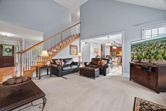 1108 Independence Ave, Elburn, IL 60119 - living room featuring high vaulted ceiling, stairs, a chandelier, and healthy amount of natural light