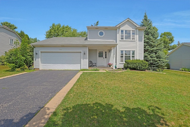 710 Cimarron Dr, Cary, IL 60013 - traditional-style house featuring driveway, an attached garage, and a front lawn