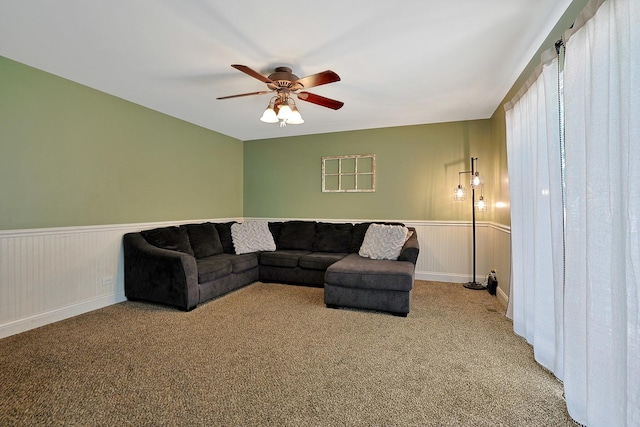 710 Cimarron Dr, Cary, IL 60013 - living area featuring light colored carpet, a ceiling fan, and a wainscoted wall