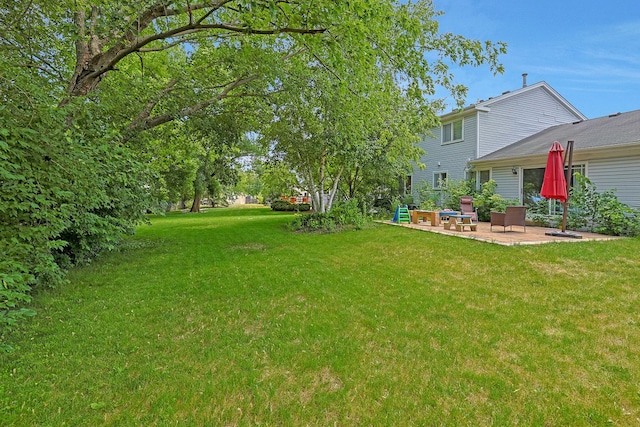 710 Cimarron Dr, Cary, IL 60013 - view of grassy yard featuring a patio