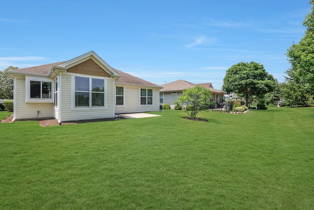 12856 W Rocksprings Ln, Huntley, IL 60142 - rear view of house featuring a lawn and a shingled roof