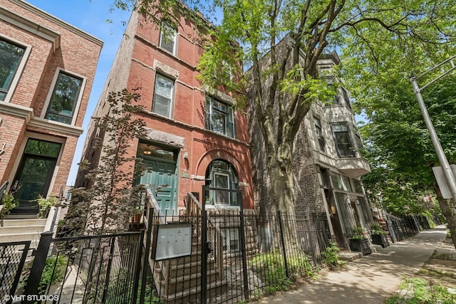 1734 W Erie St Unit 3, Chicago, IL 60622 - view of front of home with brick siding, a fenced front yard, and a gate