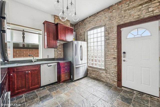 1734 W Erie St Unit 3, Chicago, IL 60622 - kitchen with appliances with stainless steel finishes, reddish brown cabinets, stone tile floors, and pendant lighting