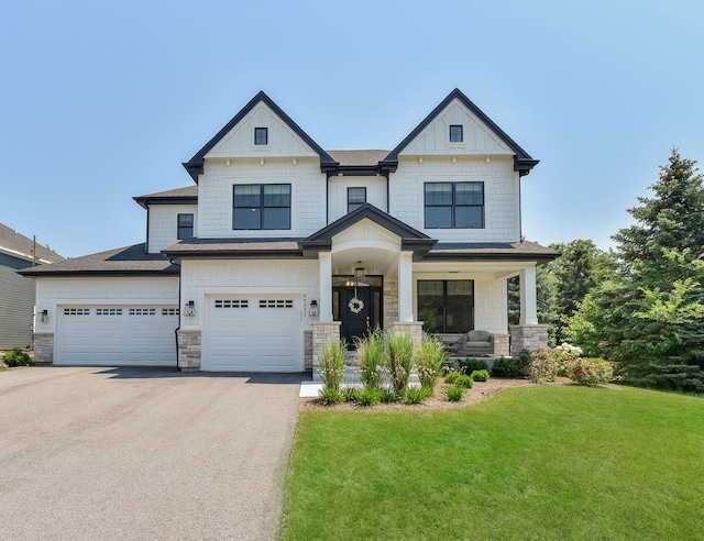 0N337 Herrick Dr, Wheaton, IL 60187 - craftsman-style house featuring asphalt driveway, a front lawn, stone siding, a porch, and board and batten siding