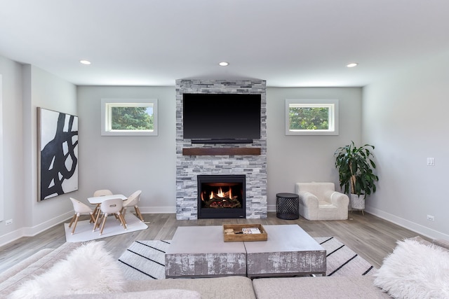 0N337 Herrick Dr, Wheaton, IL 60187 - living room featuring plenty of natural light, a stone fireplace, wood finished floors, and recessed lighting