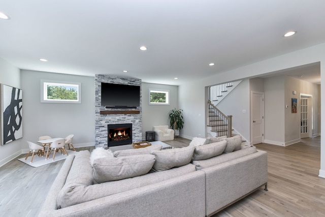 0N337 Herrick Dr, Wheaton, IL 60187 - living area with stairway, light wood-style floors, a stone fireplace, and recessed lighting