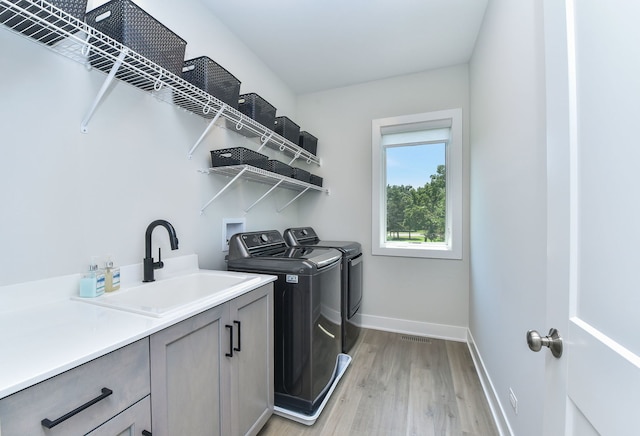 0N337 Herrick Dr, Wheaton, IL 60187 - washroom with washing machine and dryer, light wood-style flooring, and cabinet space
