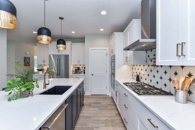 0N337 Herrick Dr, Wheaton, IL 60187 - kitchen featuring appliances with stainless steel finishes, wall chimney range hood, white cabinets, light wood-style floors, and recessed lighting