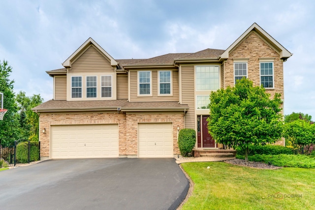 1174 Pine Tree Ct, Lake Villa, IL 60046 - view of front of property with asphalt driveway, an attached garage, and stone siding