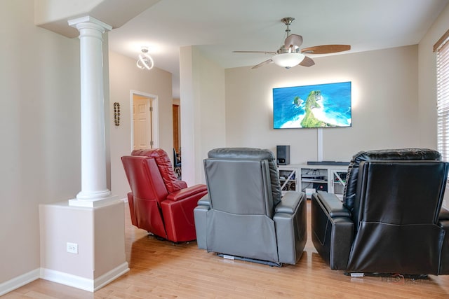 1174 Pine Tree Ct, Lake Villa, IL 60046 - home theater with decorative columns, ceiling fan, and light wood-style floors