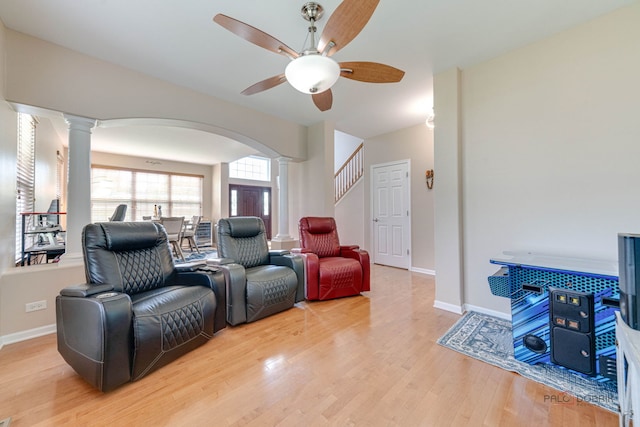 1174 Pine Tree Ct, Lake Villa, IL 60046 - living room with ornate columns, a ceiling fan, arched walkways, and light wood finished floors