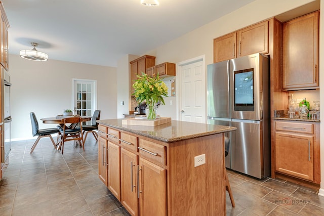 1174 Pine Tree Ct, Lake Villa, IL 60046 - kitchen featuring smart refrigerator, a kitchen island, light stone countertops, tile patterned flooring, and oven