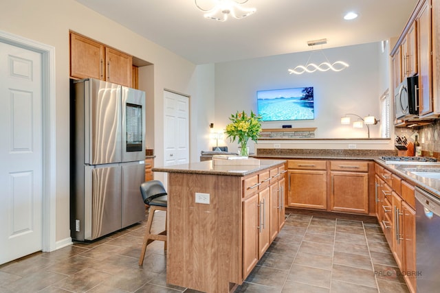 1174 Pine Tree Ct, Lake Villa, IL 60046 - kitchen with appliances with stainless steel finishes, tile patterned floors, stone countertops, a kitchen bar, and recessed lighting