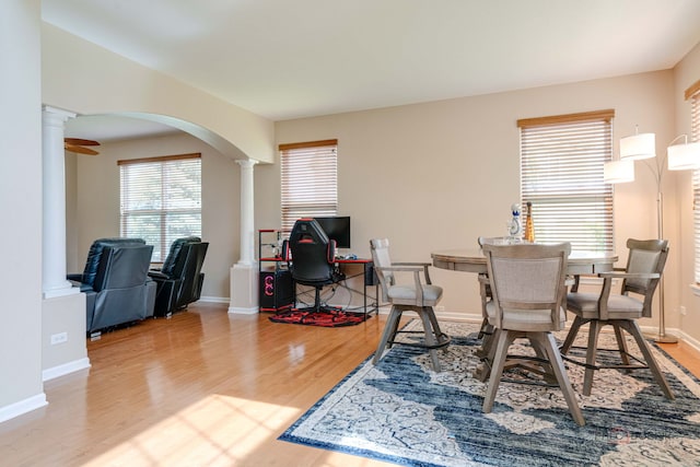 1174 Pine Tree Ct, Lake Villa, IL 60046 - dining room with decorative columns, wood finished floors, and arched walkways