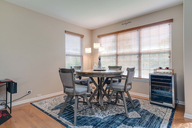 1174 Pine Tree Ct, Lake Villa, IL 60046 - dining space featuring beverage cooler, plenty of natural light, and wood finished floors