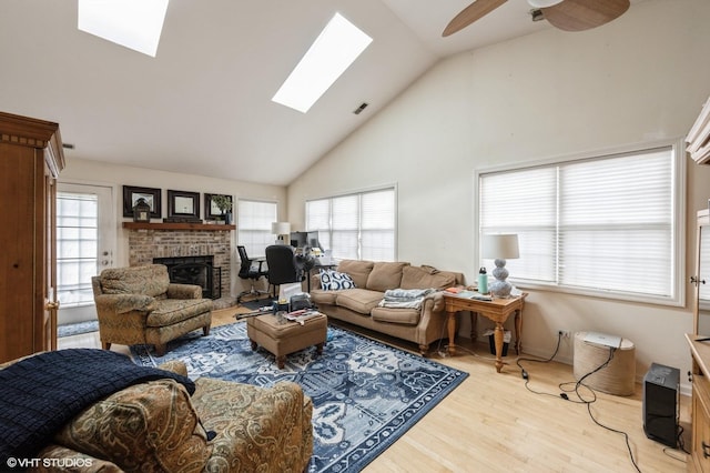 573 W Parkside Dr, Palatine, IL 60067 - living area with a skylight, light wood finished floors, high vaulted ceiling, plenty of natural light, and a fireplace